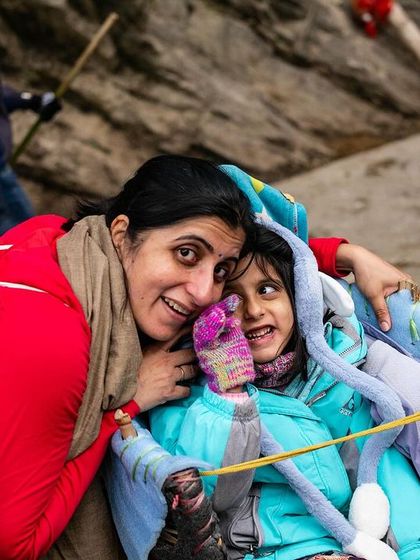 The pilgrimage to the Himalayas is a journey for all ages, often undertaken as a family. Here, a mother and child share a moment of connection and care on the trail to Kedarnath. It is a testament to the faith that drives families to these sacred heights together.