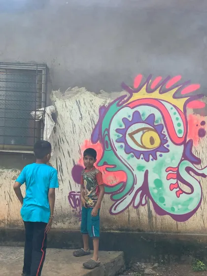 This is my 'psyganesh' character, a psychedelic interpretation of Ganesha. It's a way for me to connect my spiritual side with my street art style, watched by some local kids.