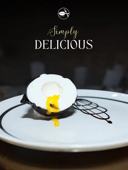 This is my Mango Coconut Shell dessert, a true showstopper. Guests get to crack open a delicate chocolate shell to reveal a luscious mango and coconut mousse center, offering a delightful tropical surprise.
