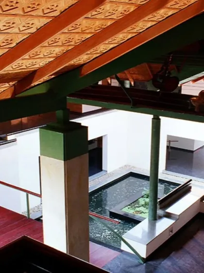 An elevated view of an interior courtyard at the LMW Headquarters. A water body, a red wooden bridge, and patterned terracotta roof tiles showcase my approach of blending traditional materials and spatial concepts in a contemporary design.