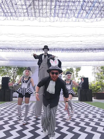 Our creativity extends to daytime events with unique concepts like this 'Line Art Carnival'. We bring themes to life with interactive elements, including costumed performers on stilts who engage with guests and enhance the whimsical, artistic atmosphere.