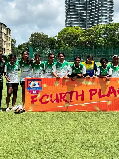 Our U17 girls team and coaches pose with a "Fourth Place" banner after the MFA Girls YPL season. This photo celebrates their hard work and proud finish in a long and challenging league.