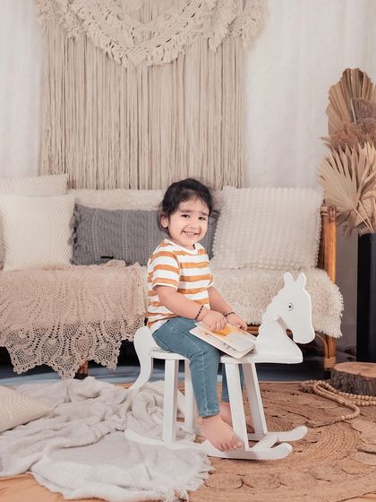 Another shot of these two adorable sisters. The natural, earthy tones of the studio setup provide a beautiful, warm backdrop for their sibling portrait.