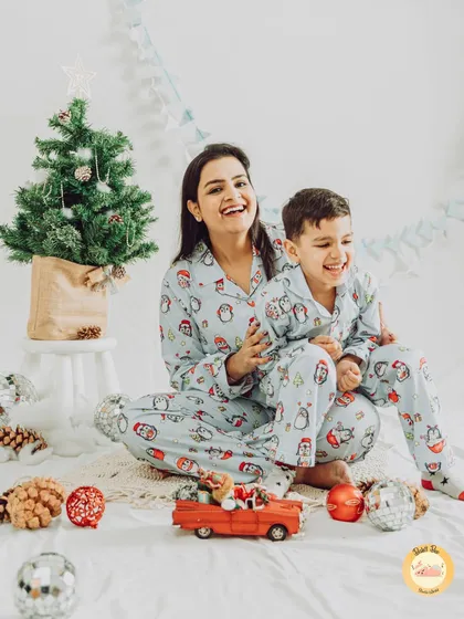 Cozy Christmas morning vibes with mom and son in matching pajamas. We create warm and joyful holiday sets perfect for creating your annual Christmas card photos.
