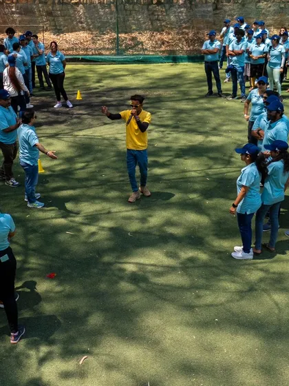 A team huddles up to strategize during a team building game. It's moments like these that strengthen bonds outside the office.