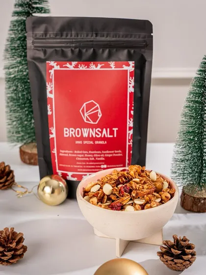 Our Xmas Special Granola in a bowl, surrounded by festive decorations. It's a popular item for holiday snacking and gifting.