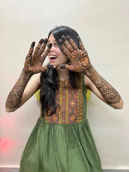 The pure joy of a bride with her wedding henna. Her expression says it all!