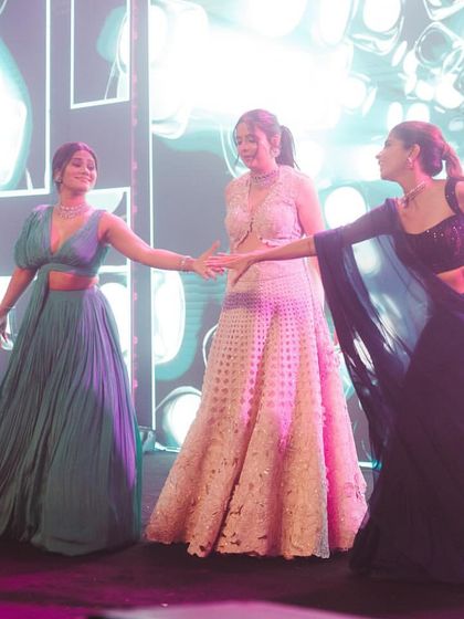 A sweet moment between the bride and her sisters on stage. I love choreographing dances that celebrate the special bond between siblings.