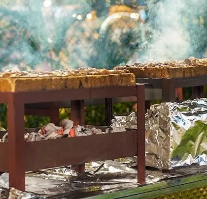 The smoky and aromatic setup of our live BBQ station, where we grill a variety of kebabs and meats over hot coals.