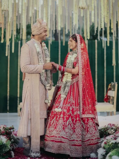 A full-length view of Jigisha's stunning bridal look, showing how the makeup complements the entire ensemble.