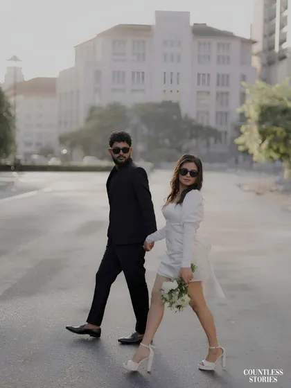 There is a certain magic to an empty city street at dawn. For this shoot, we embraced a modern, chic aesthetic, creating images that feel like stills from a contemporary film. The contrast of their black and white outfits against the urban architecture tells a story of confident, stylish love.