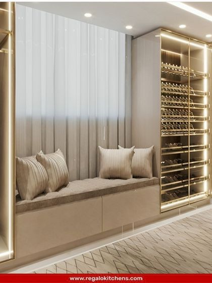 This wardrobe design includes a window bench, creating a bright and comfortable spot to relax. The glass-fronted cabinets are perfect for displaying a wine or shoe collection.