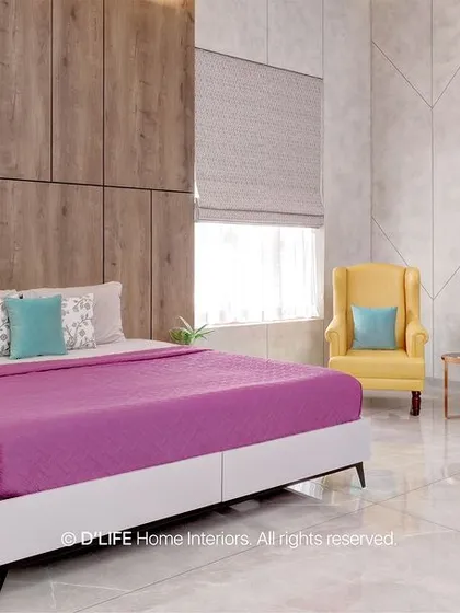 This bedroom design uses a pop of color with a magenta bedspread against a neutral backdrop of white marble-patterned walls and wood-finish wardrobes.