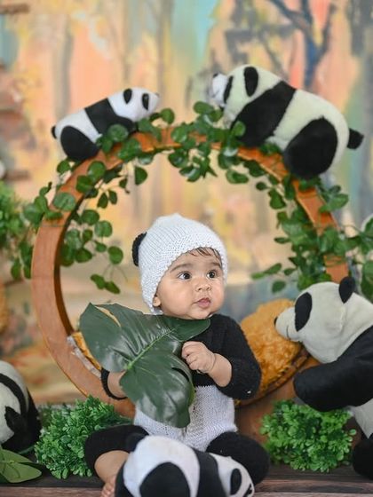 This little panda is curiously exploring a leaf. These candid, interactive moments make for wonderful photos.