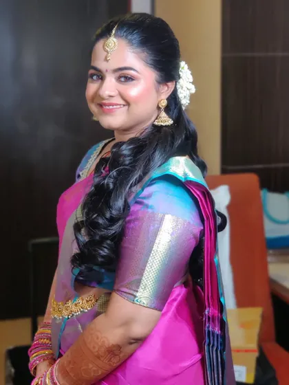 A happy and smiling Pavitra. Her skin is glowing, and the makeup is subtle enough to let her natural beauty and happiness shine through.