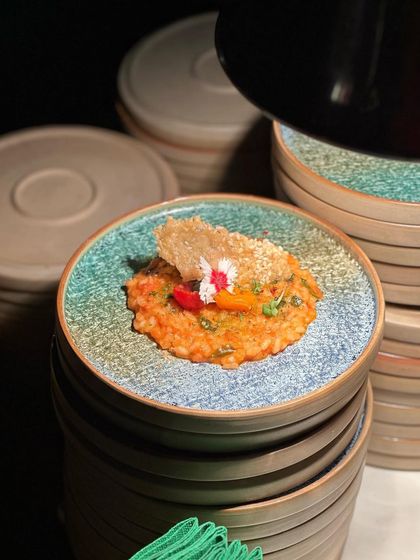 The contrast of the colourful risotto against the dark, earthy plate creates a stunning visual. We pay close attention to our choice of crockery to complement the food.