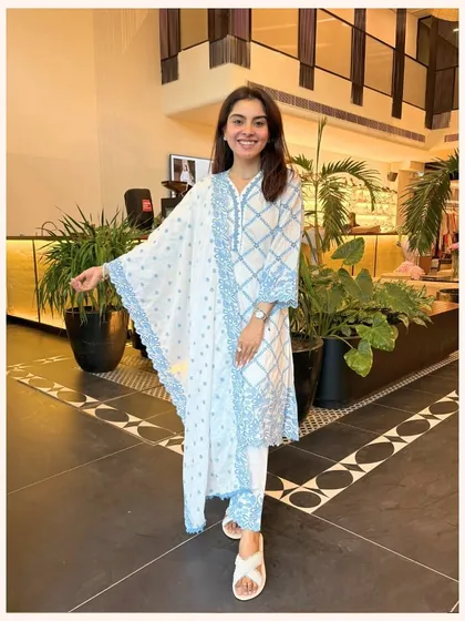 This white and blue printed kurta set is a classic. The geometric print and lace-trimmed dupatta create a look that is both traditional and modern.