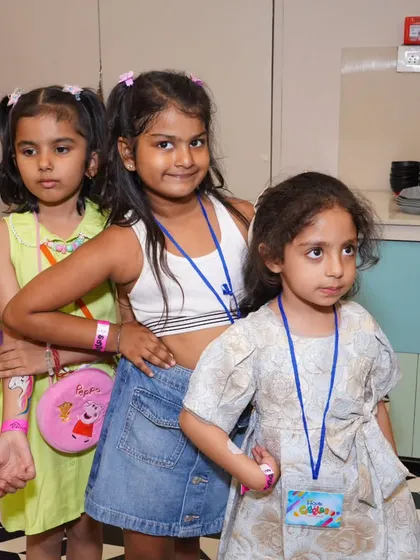 The party crew is here! A group of friends posing together, showing off their party wristbands. It's wonderful to see friendships and fun blossoming at our celebrations.