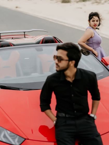 A cool, confident pose from the groom against the red Lamborghini in the desert.