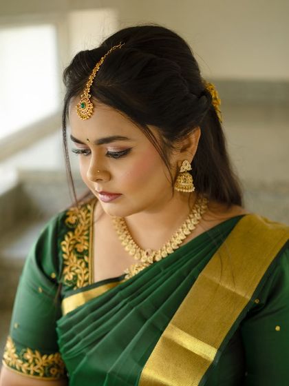 A close-up of Dr. Meghana's makeup, showing the soft, neutral eyeshadow and perfectly defined brows that complete her traditional look.