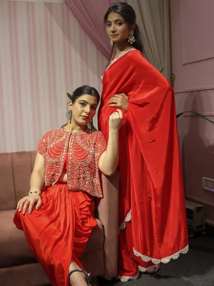 A powerful shot of me and a model wearing two different red outfits from the 'DESIRE' collection.