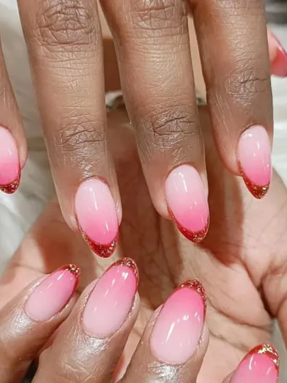 A closer view of the pink ombre nails with a delicate red glitter tip, showcasing the smooth color transition.