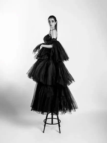 Elegance in monochrome. This shot from a couture series focuses on dramatic shapes and clean lines, proving that sometimes the most powerful statements are the most simple.