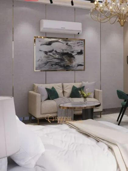 A cozy seating area within the master bedroom, with a small sofa and coffee table, perfect for unwinding before bed.
