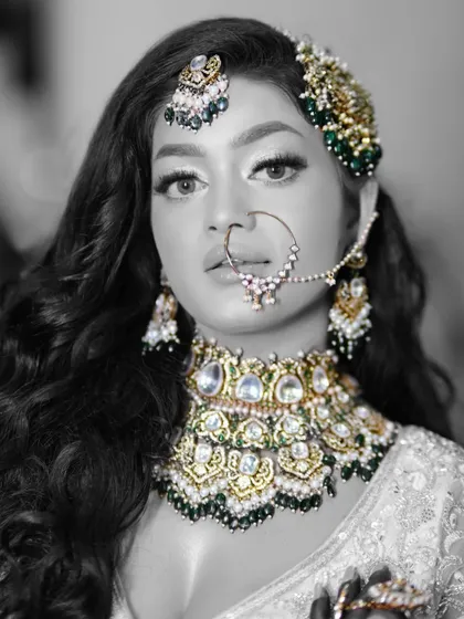 A black and white version of the portrait, which highlights the contrast and the details of the jewelry and eye makeup.