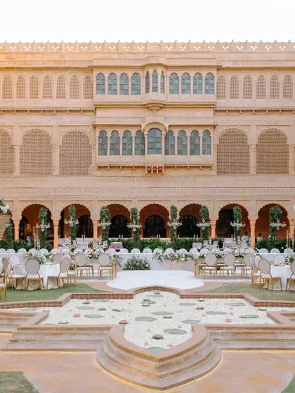 At Suryagarh, Jaisalmer, timeless elegance meets royal splendor. This image shows a beautiful daytime setup in the palace courtyard, where we blend regal architecture with our bespoke decor to create a majestic reality.