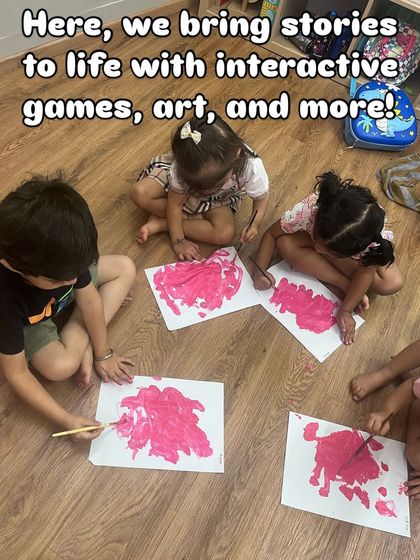 I bring stories to life with interactive games, art, and more. Here, children are painting together after a story, translating what they heard into their own creative expression.