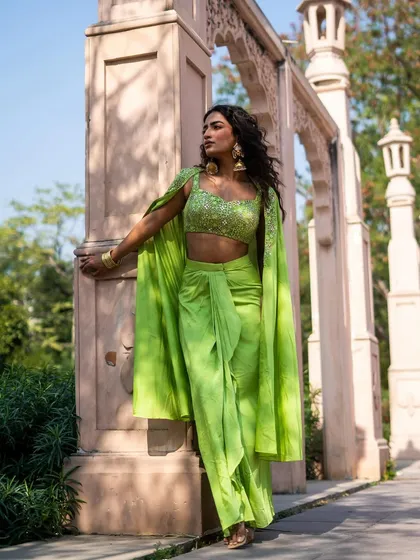 New pieces in now. This lime green dhoti pant set with an attached cape is the perfect modern mehendi outfit. It's stylish, comfortable, and lets you move freely.