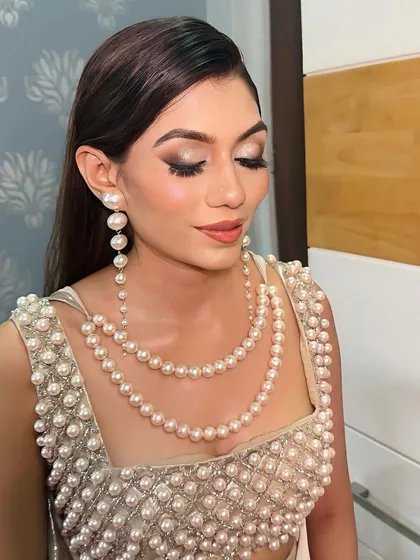 Bold and beautiful in pearls. This look features a dramatic eye, glowing skin, and a modern hairstyle, perfect for a cocktail party or reception.