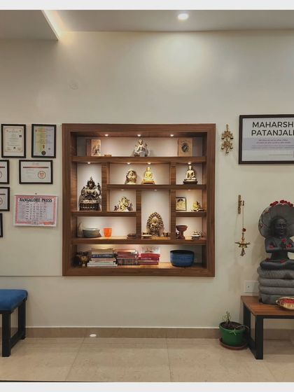Our reception area, featuring our wall of certifications and a shrine to Maharshi Patanjali. This space is where our community connects before and after class.