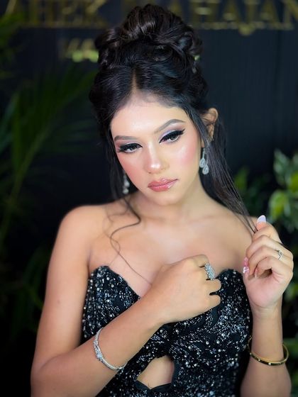 A glamorous party look with a black sequined dress. The makeup features a silver cut-crease eye and a soft pink lip, perfect for a reception or cocktail night.