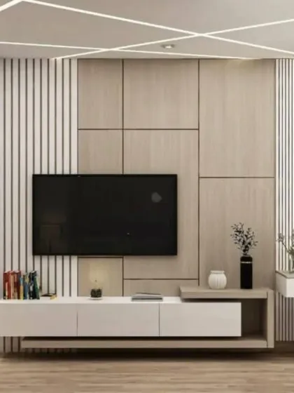 A modern TV unit design with a mix of wood panels, vertical fluting, and dark display shelves. The integrated dressing table on the side makes it a great fit for a studio apartment.