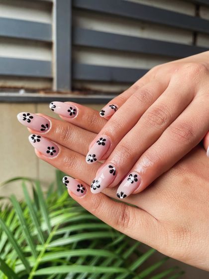 Another angle of our popular minimalist floral design. The contrast between the black flowers and the sheer nude base makes this a versatile and modern choice for any occasion.