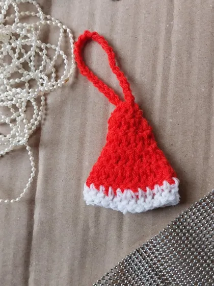 A mini Santa hat ornament, perfect for the festive season.