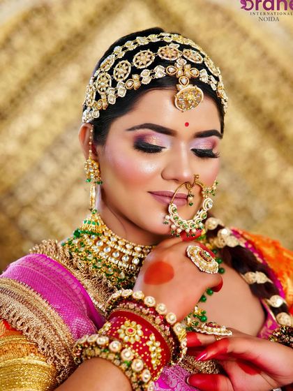 A close-up on the soft, glowing bridal makeup, showing the delicate shimmer on the eyes and the perfectly defined nose ring.