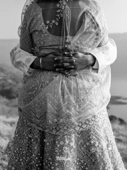A close-up, black and white shot of their hands intertwined in an embrace. It’s a powerful, anonymous image of love and belonging that transcends identity.