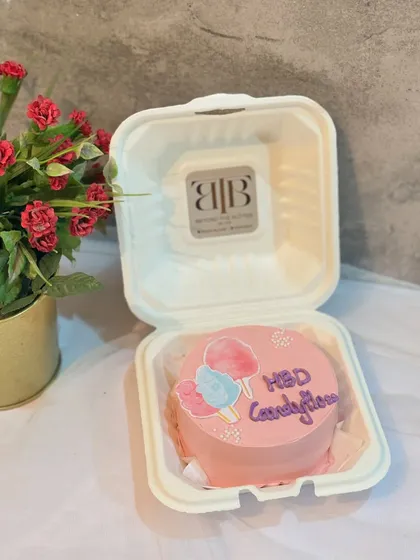 A fun birthday bento cake with a hand-painted cotton candy design, perfect for someone with a sweet tooth.