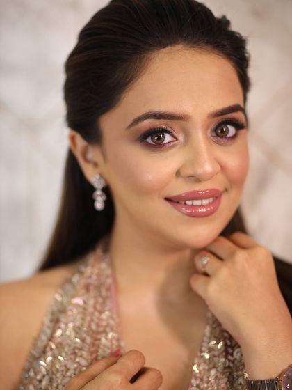 A close-up of the soft glam makeup. The eyes are the star of the show, with a beautiful blend of pink shimmer and defined lashes.