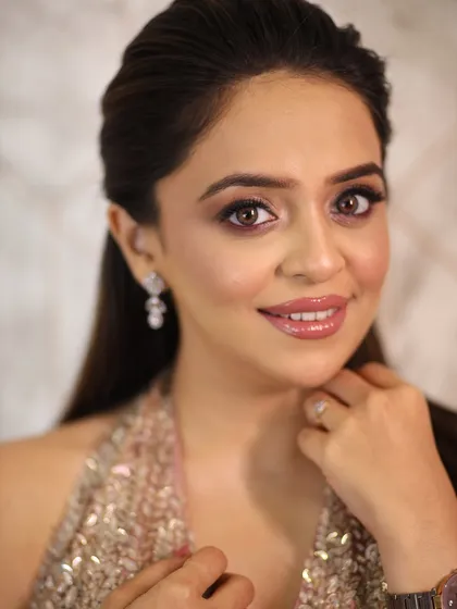 A close-up of the soft glam makeup. The eyes are the star of the show, with a beautiful blend of pink shimmer and defined lashes.