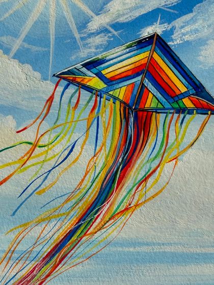 A detailed close-up of the kite, showing the intricate lines and vibrant colors against the soft blue sky.