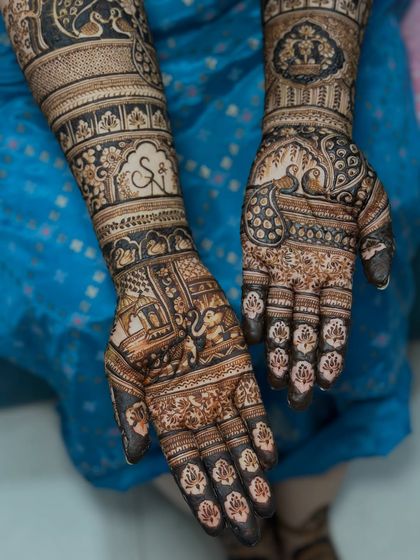 For this bride, we incorporated traditional wedding elements like elephants and palanquins, along with the couple's initials, to create a classic yet personalized bridal design.