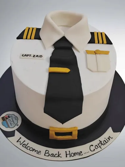 A "Welcome Back Home" cake for an Air Force Captain. The cake is designed to look like a crisp pilot's uniform, complete with epaulets and a tie.