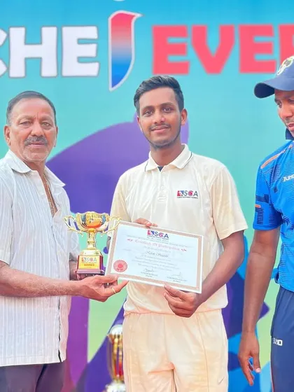 A player proudly accepts his award for contributing to the team's success.
