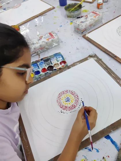 Glimpses from our summer camp, where students explore different techniques like dot painting and abstract art.