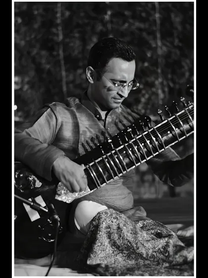 A focused black and white shot from an outdoor evening concert.
