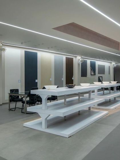 More images from the Krsimar marble showroom, detailing the sliding panel display system and the clean, spacious layout designed for an optimal client experience.